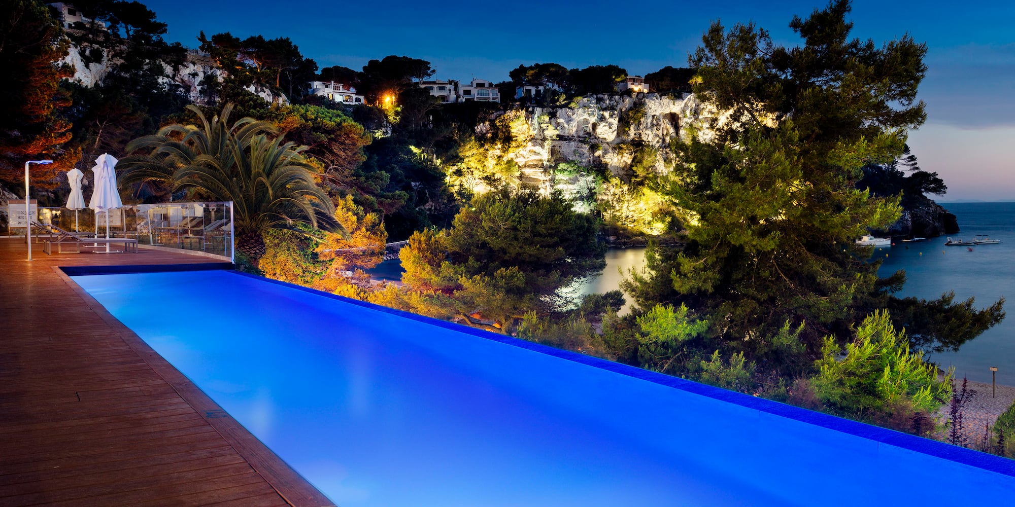 a pool with trees and a deck