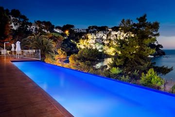 a pool with trees and a deck