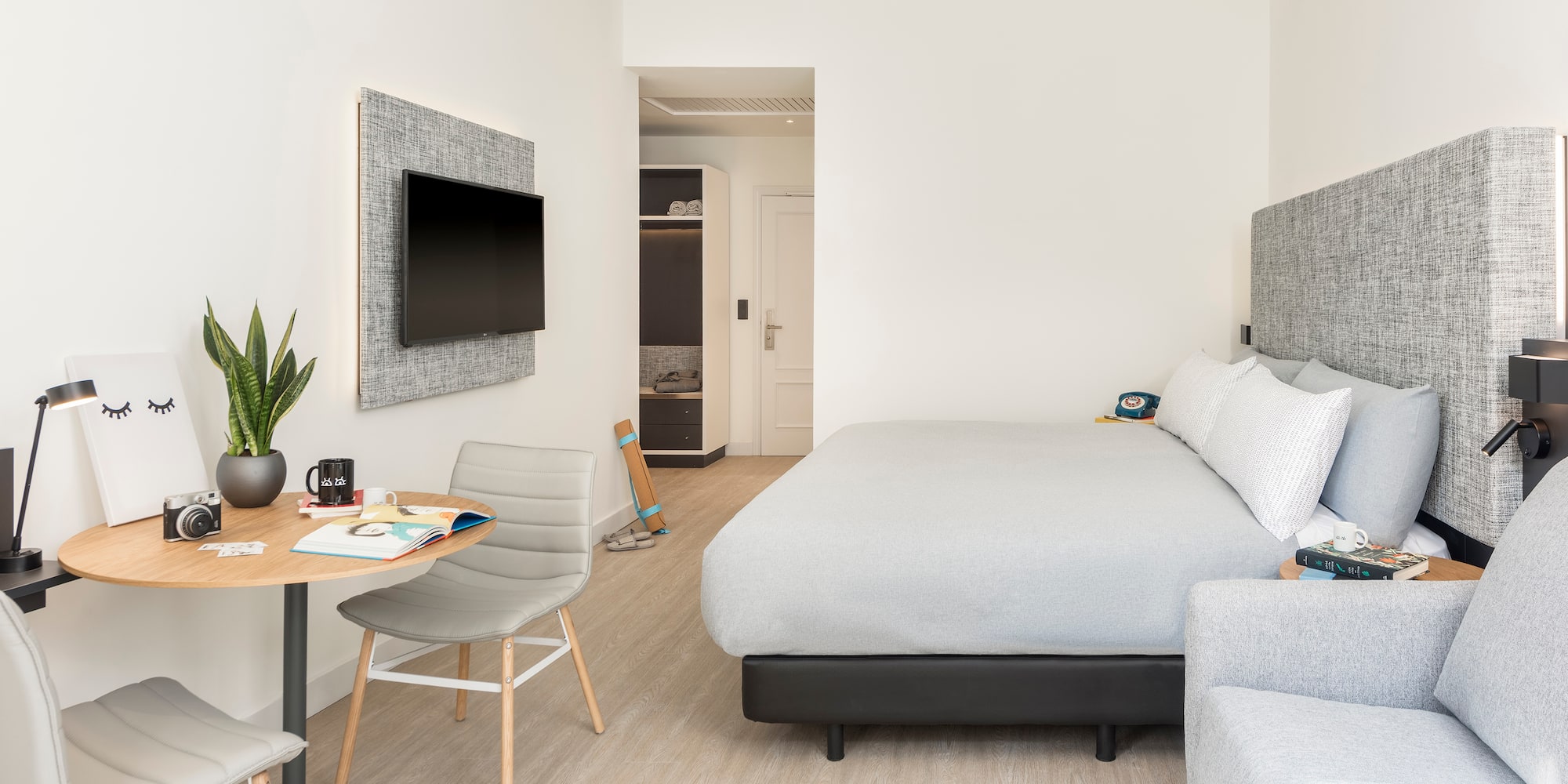 a bedroom with a bed and a tv