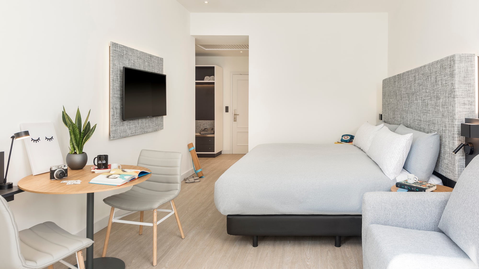 a bedroom with a bed and a tv