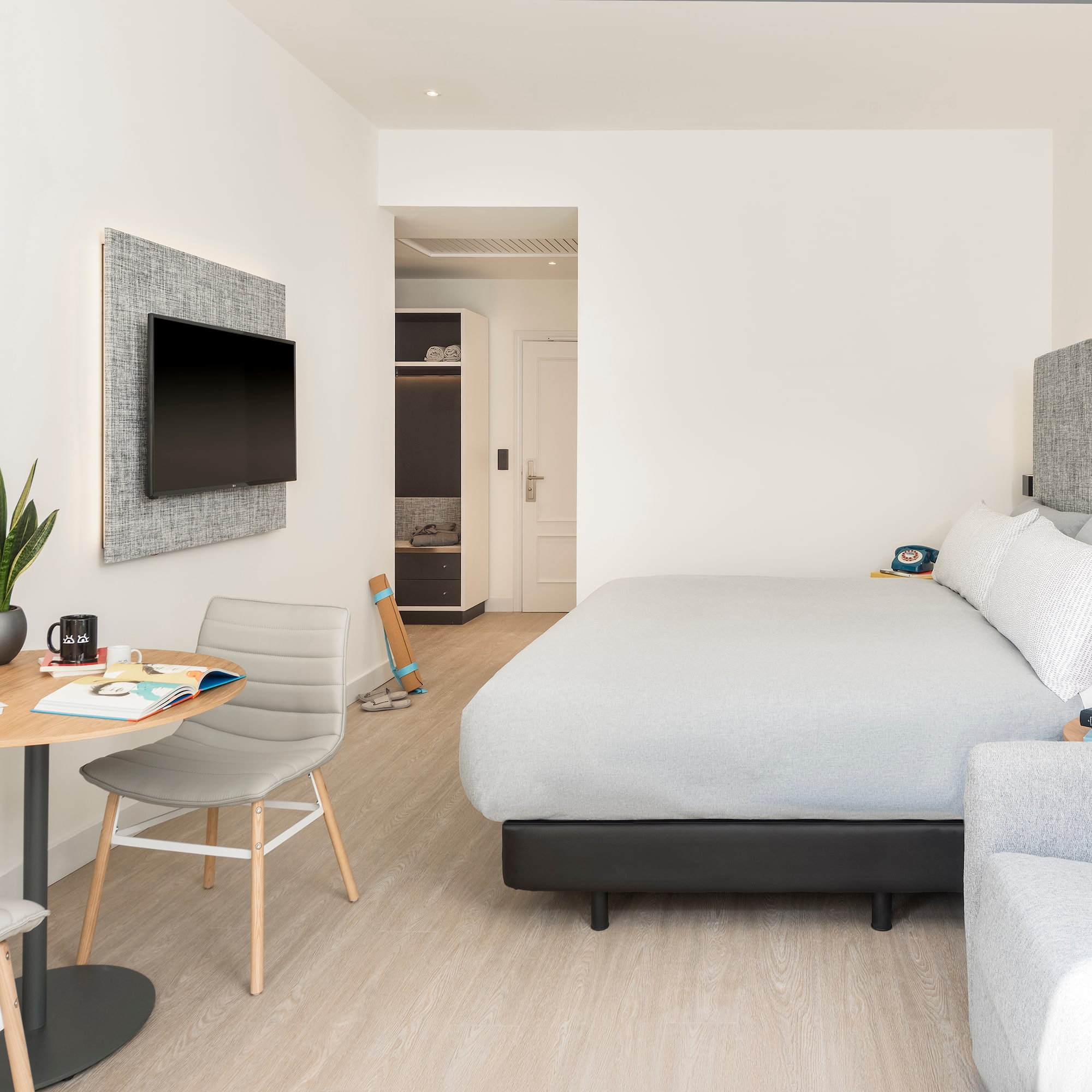 a bedroom with a bed and a tv