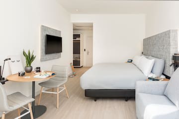 a bedroom with a bed and a tv