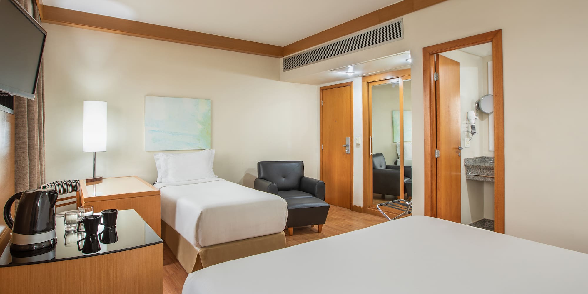 a room with two beds and a chair