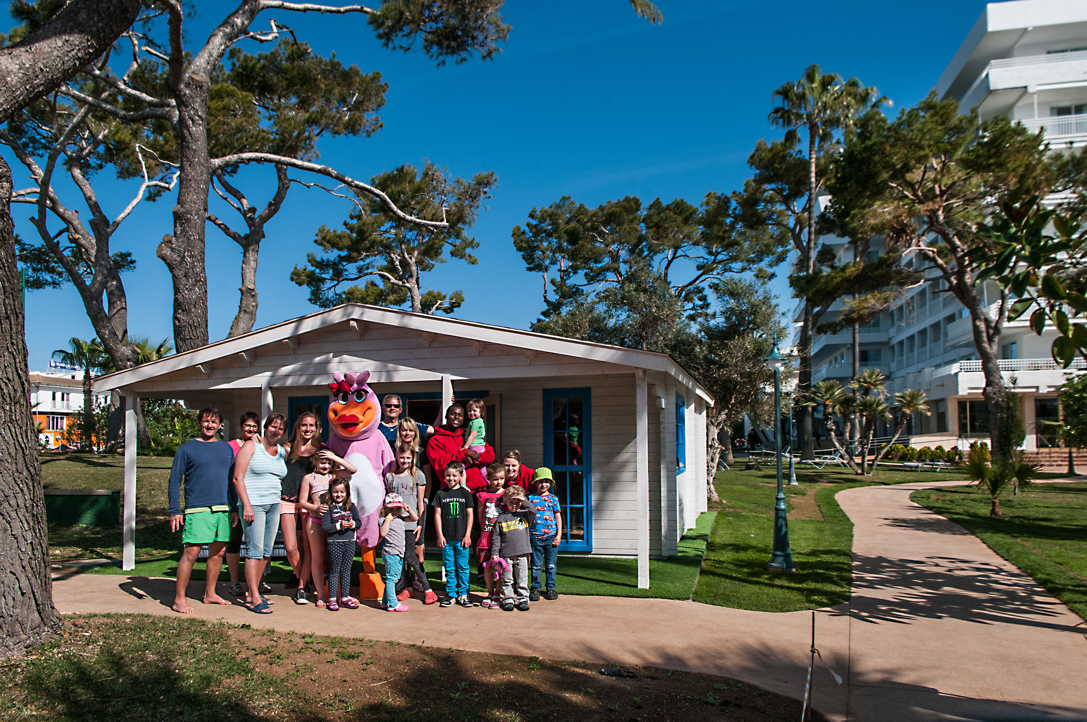 a group of people standing in front of a house
