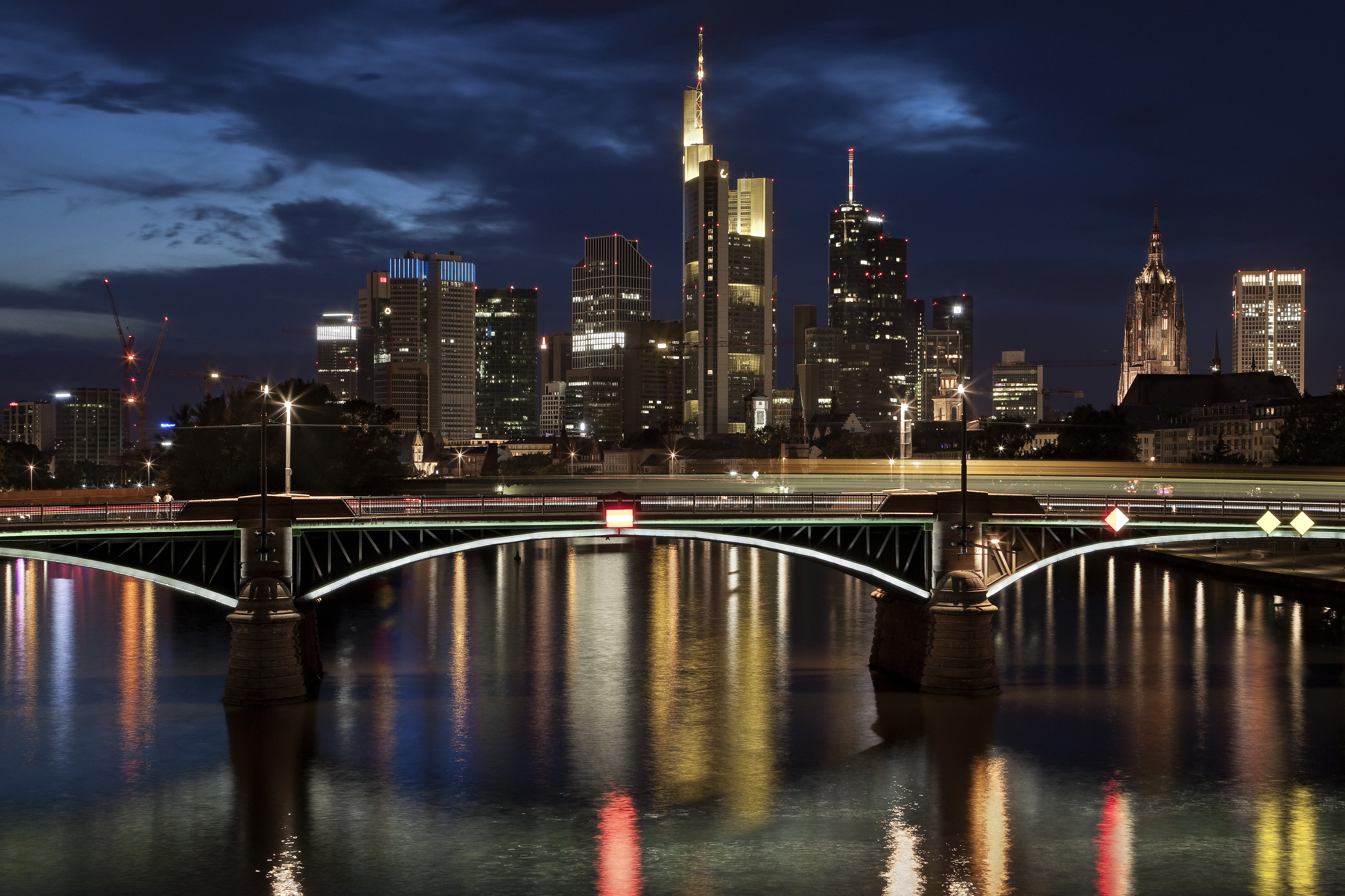 a bridge over water with a city in the background