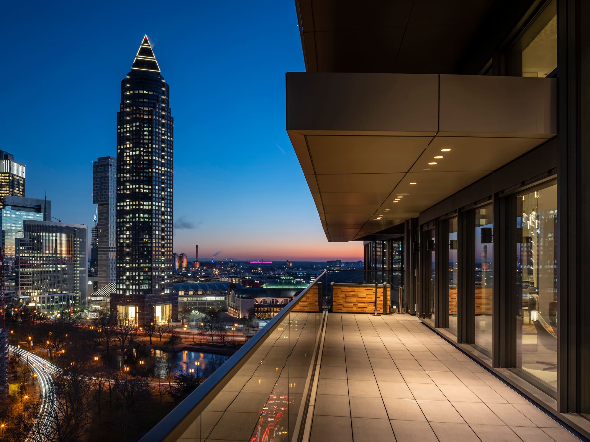 a balcony with a view of a city and a skyscraper