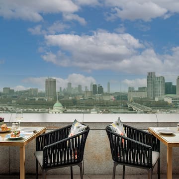 a table and chairs with a view of a city