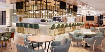 a room with a bar and chairs