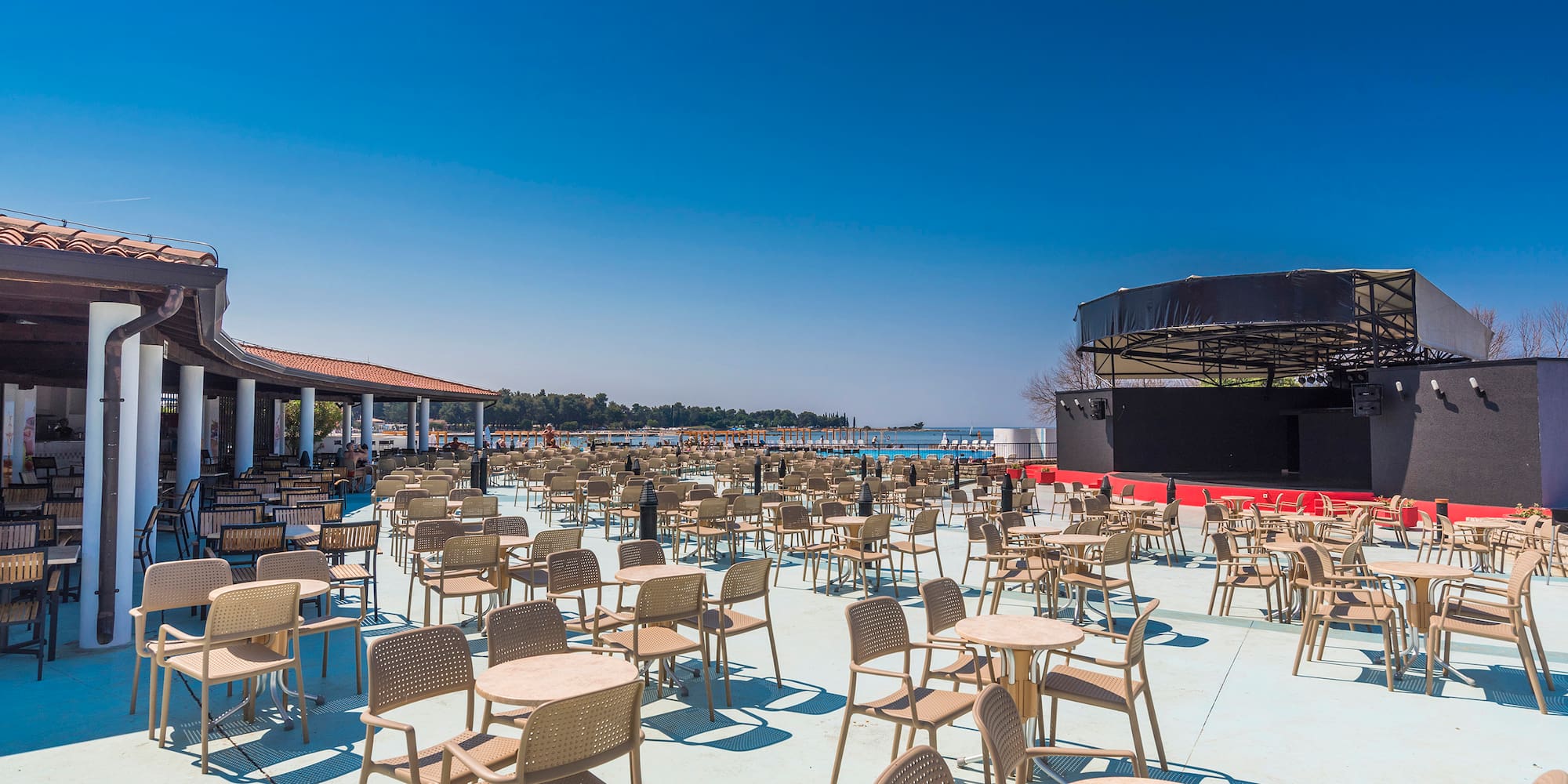 a large outdoor restaurant with tables and chairs