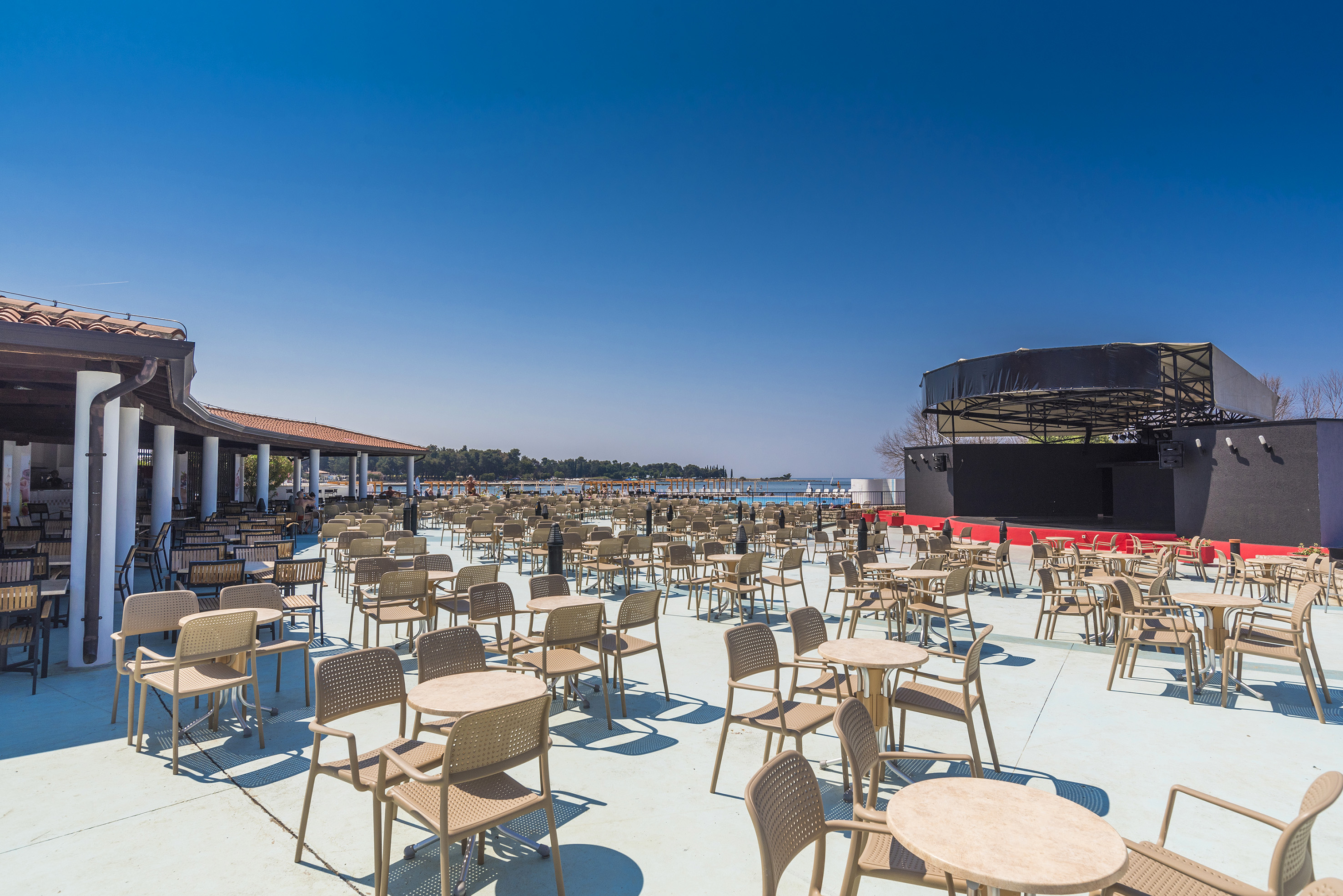 a large outdoor restaurant with tables and chairs