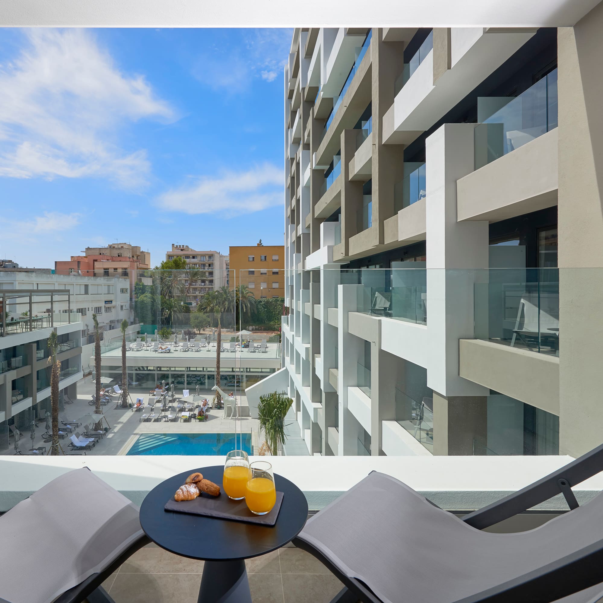 a table with two chairs and a drink on it
