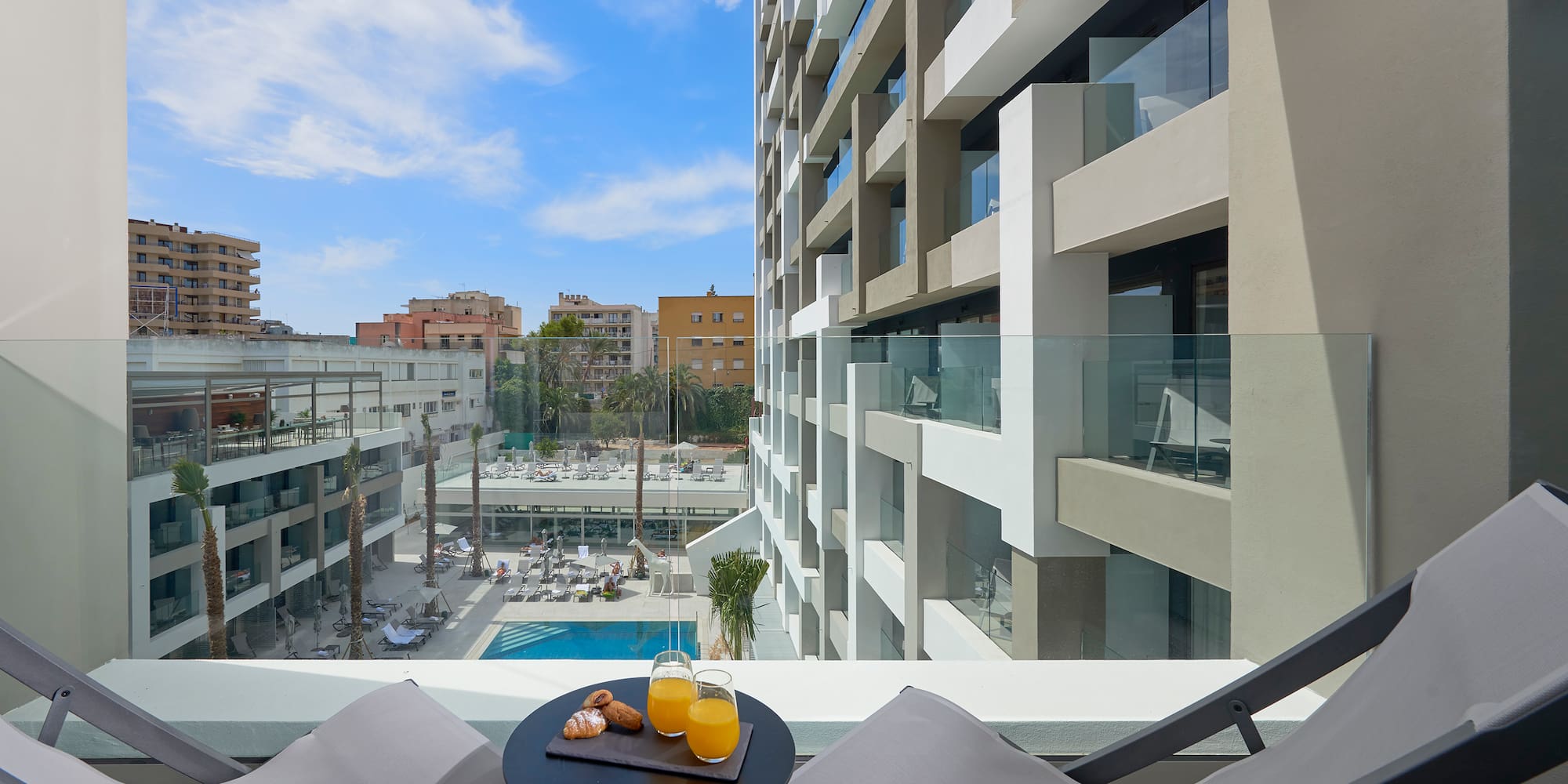 a table with two chairs and a drink on it