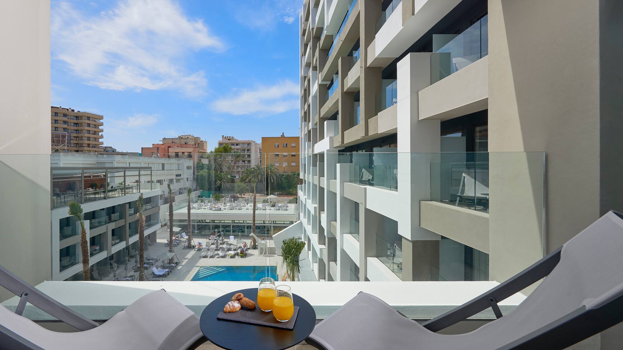 a table with two chairs and a drink on it