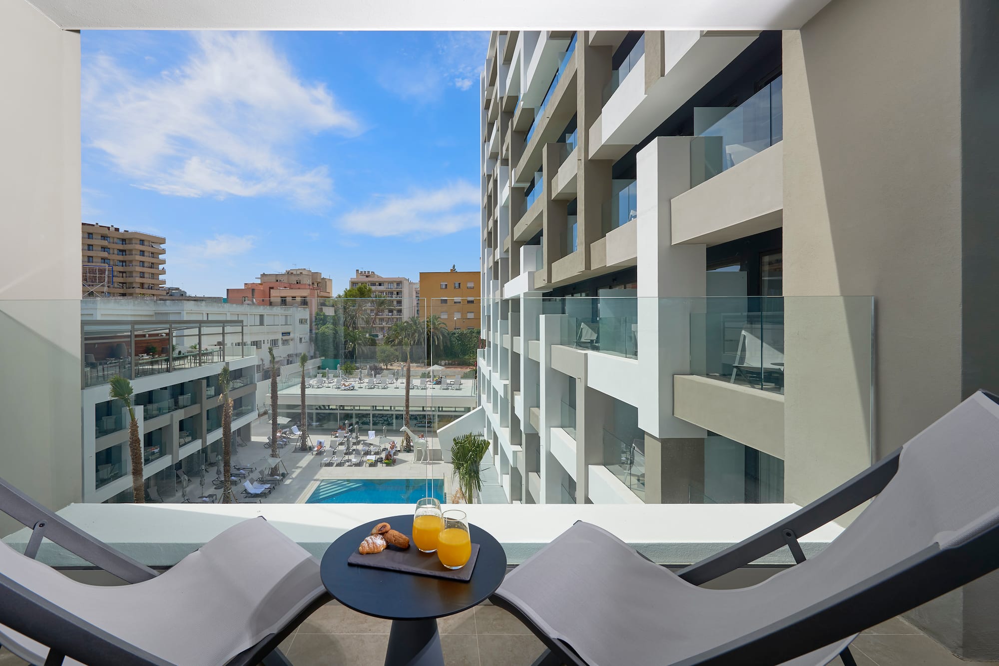 a table with two chairs and a drink on it