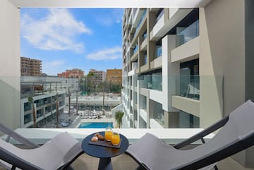 a table with two chairs and a drink on it