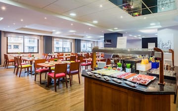 a restaurant with many tables and chairs