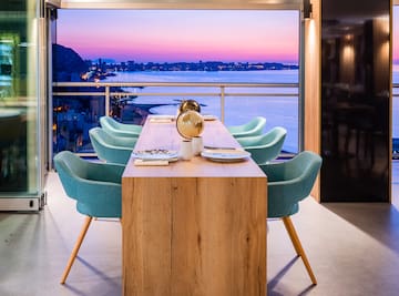 a table with chairs and a view of the city from the window