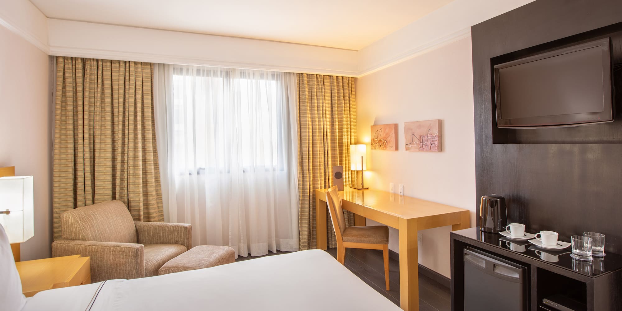 a room with a bed and a television