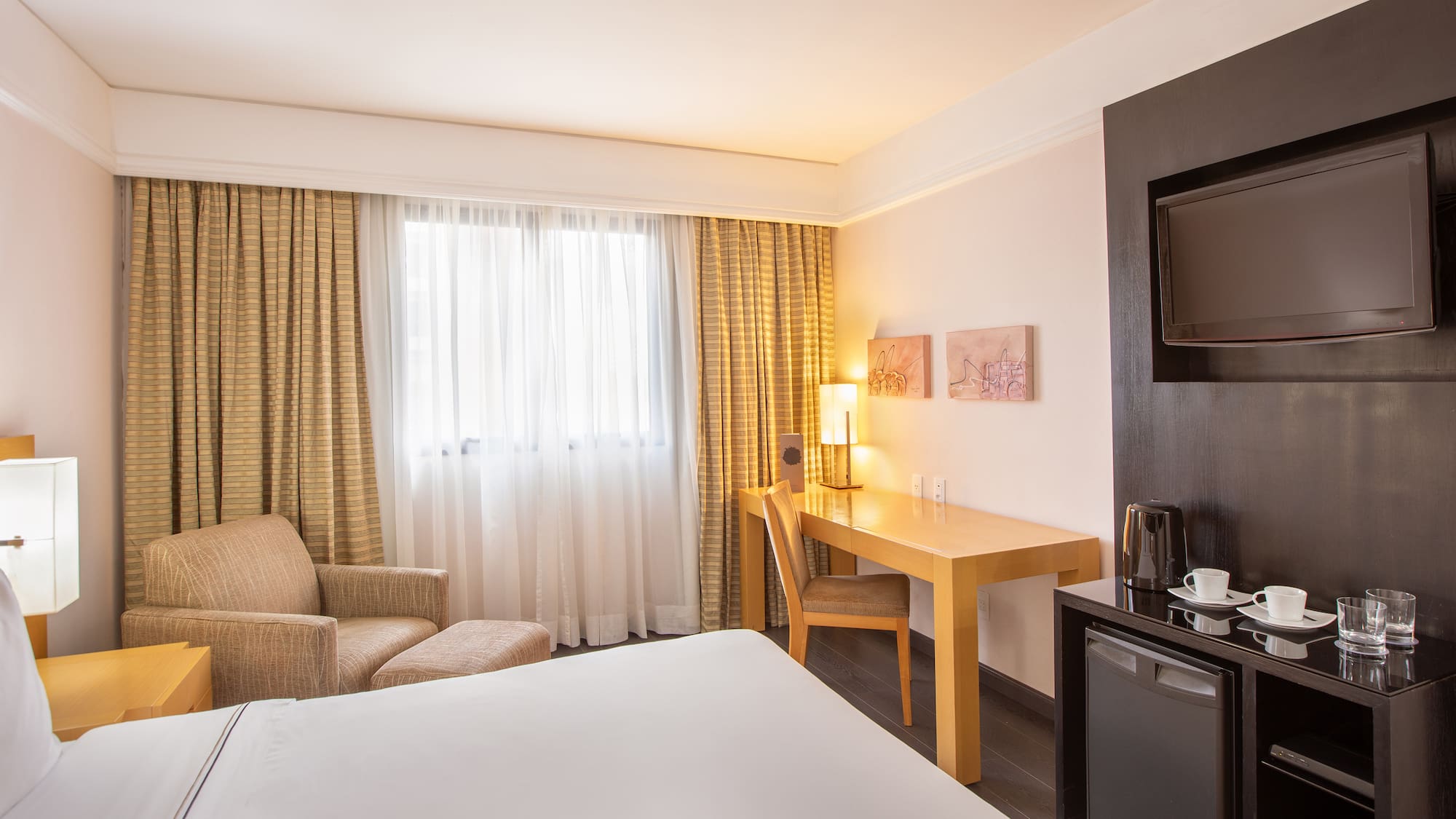 a room with a bed and a television