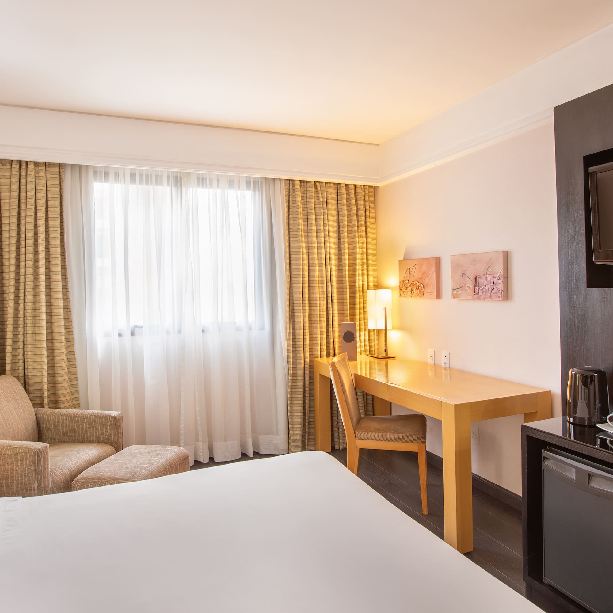 a room with a bed and a television