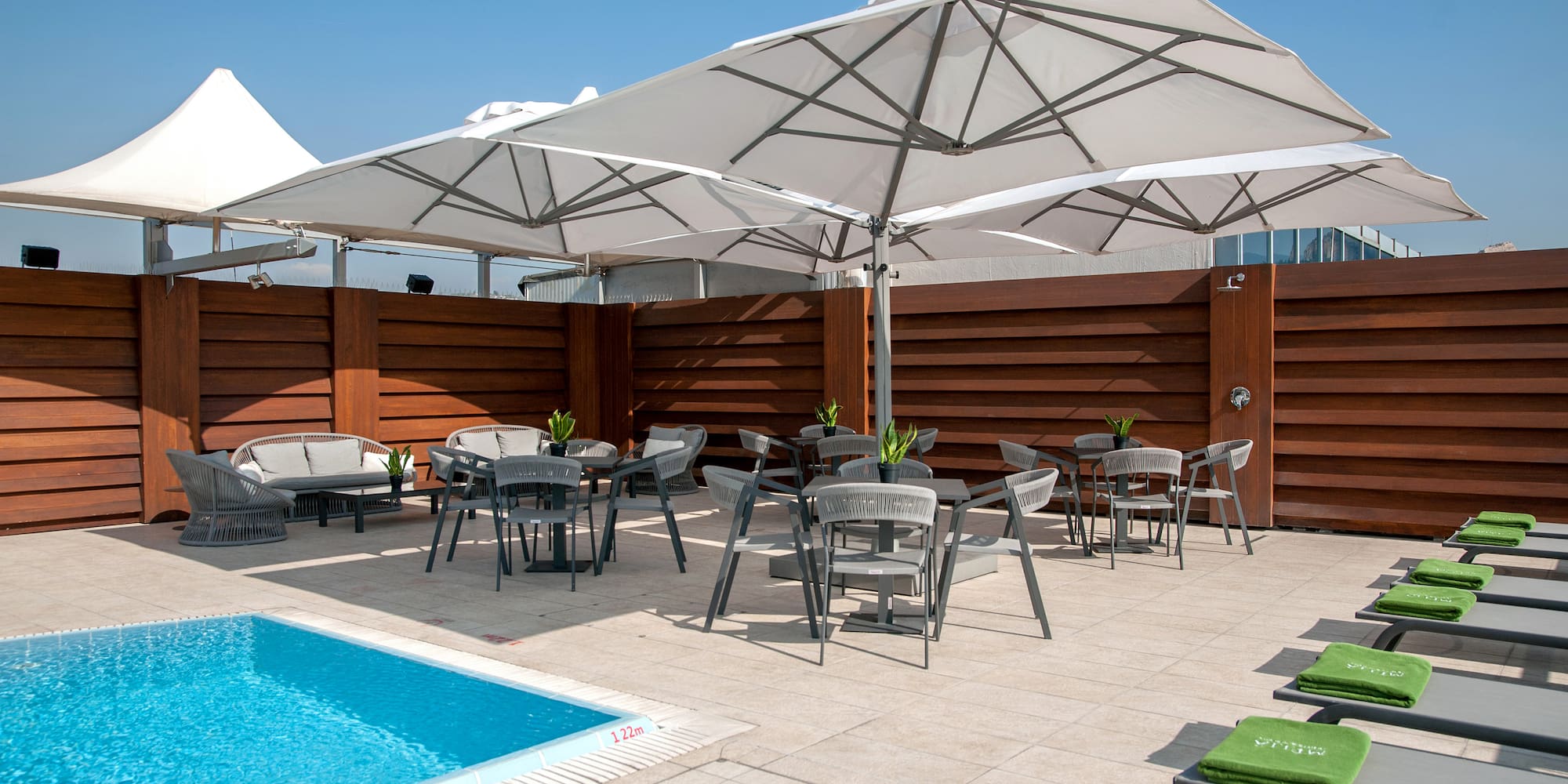 a pool with chairs and umbrellas