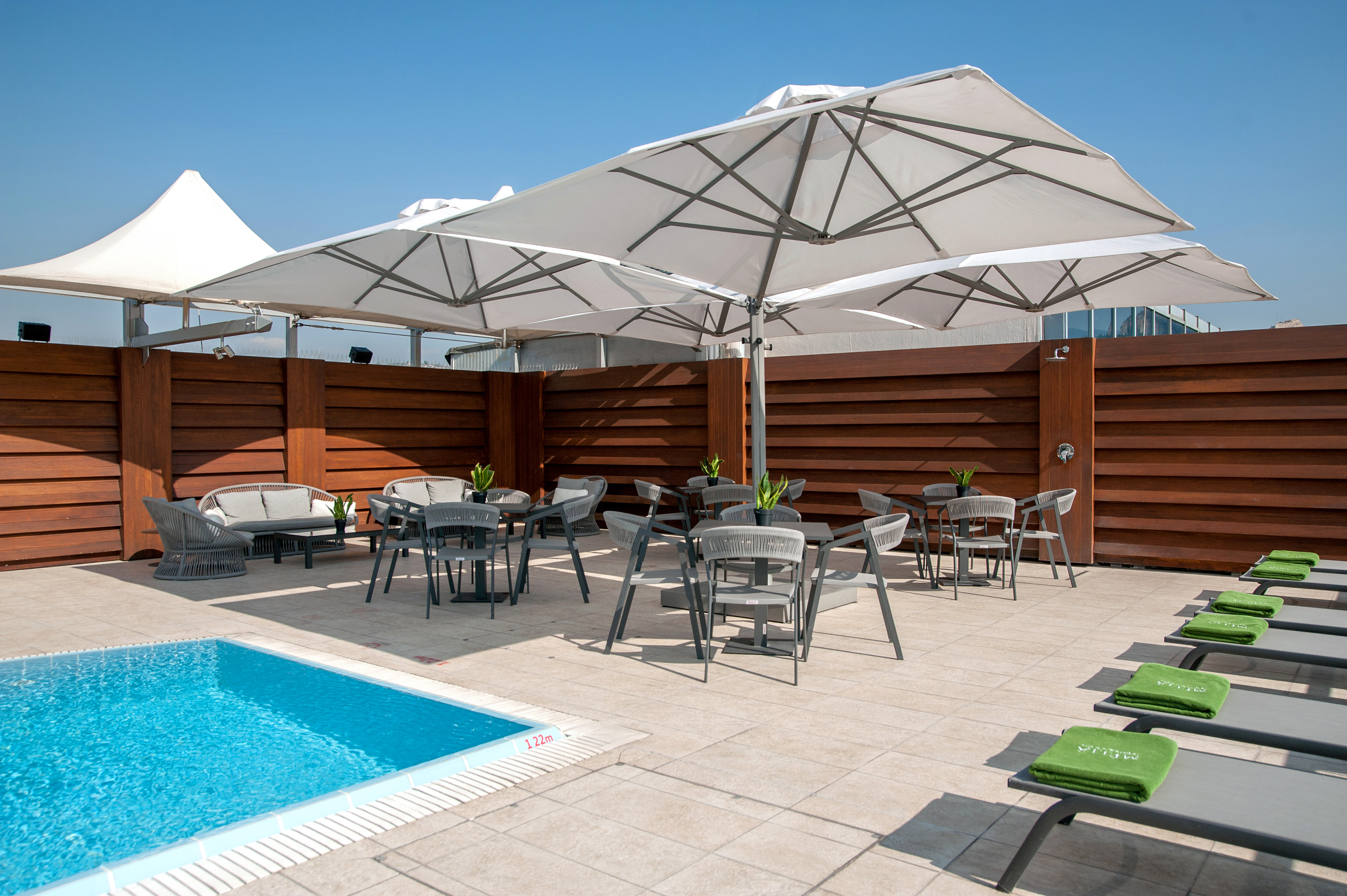 a pool with chairs and umbrellas
