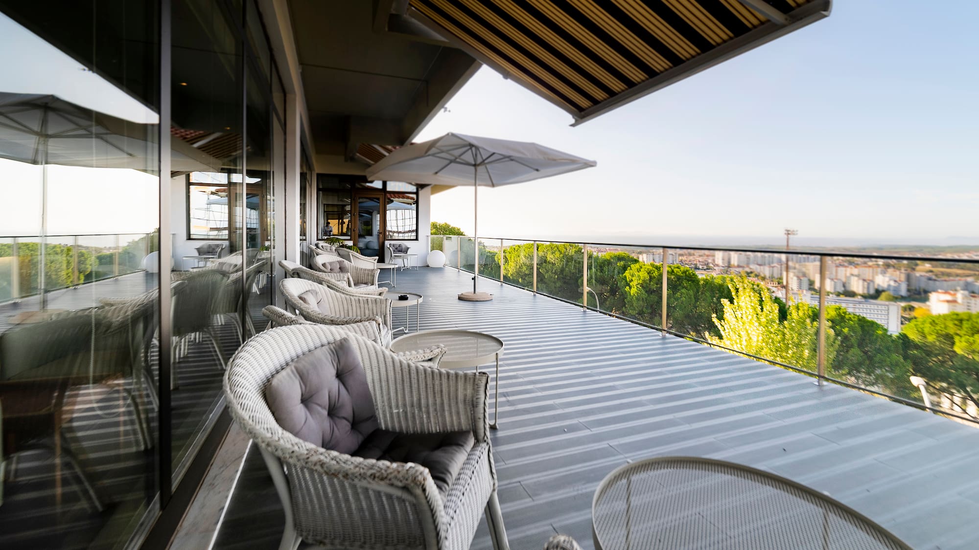 a patio with chairs and umbrellas