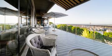 a patio with chairs and umbrellas