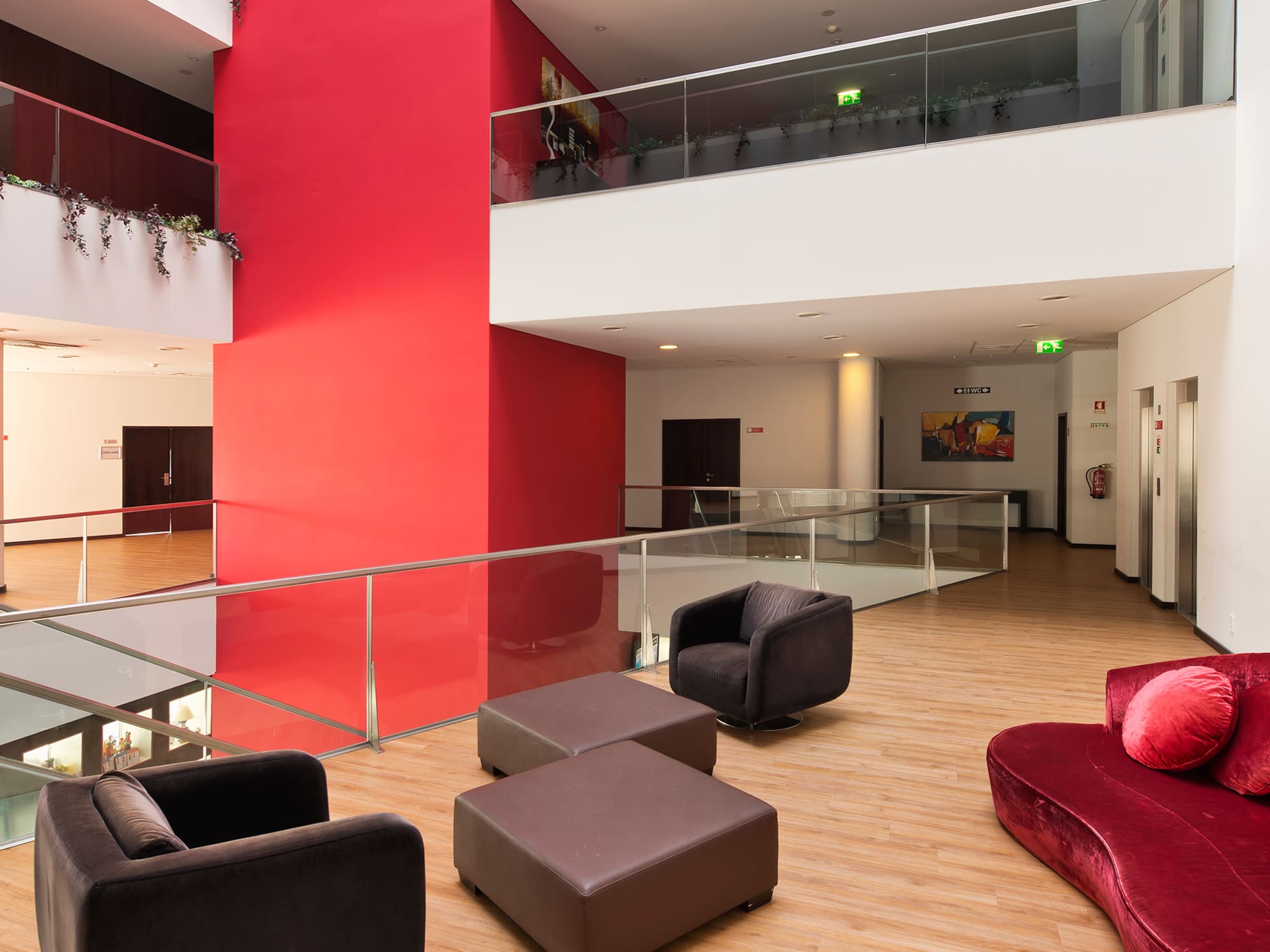 a room with a red wall and a red wall and a red couch