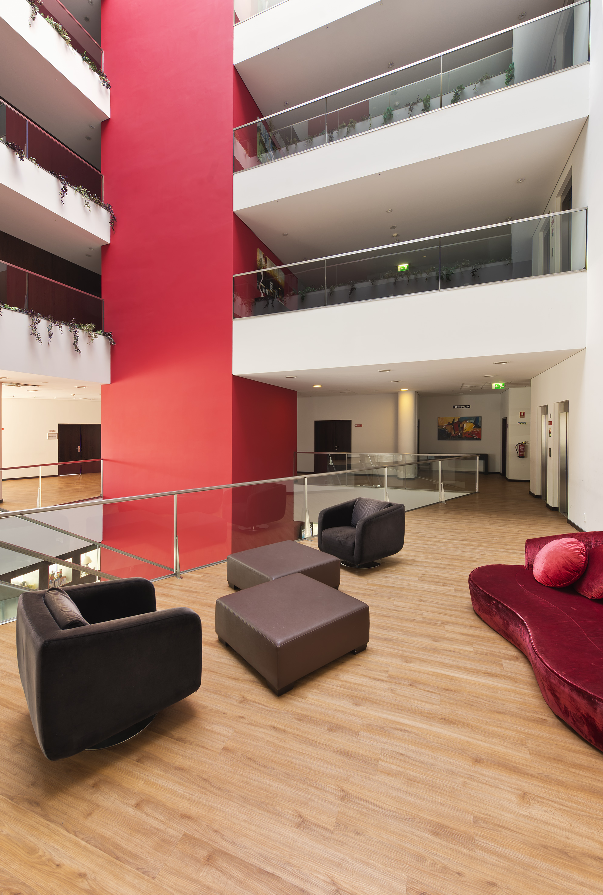 a room with a red wall and a red wall and a red couch