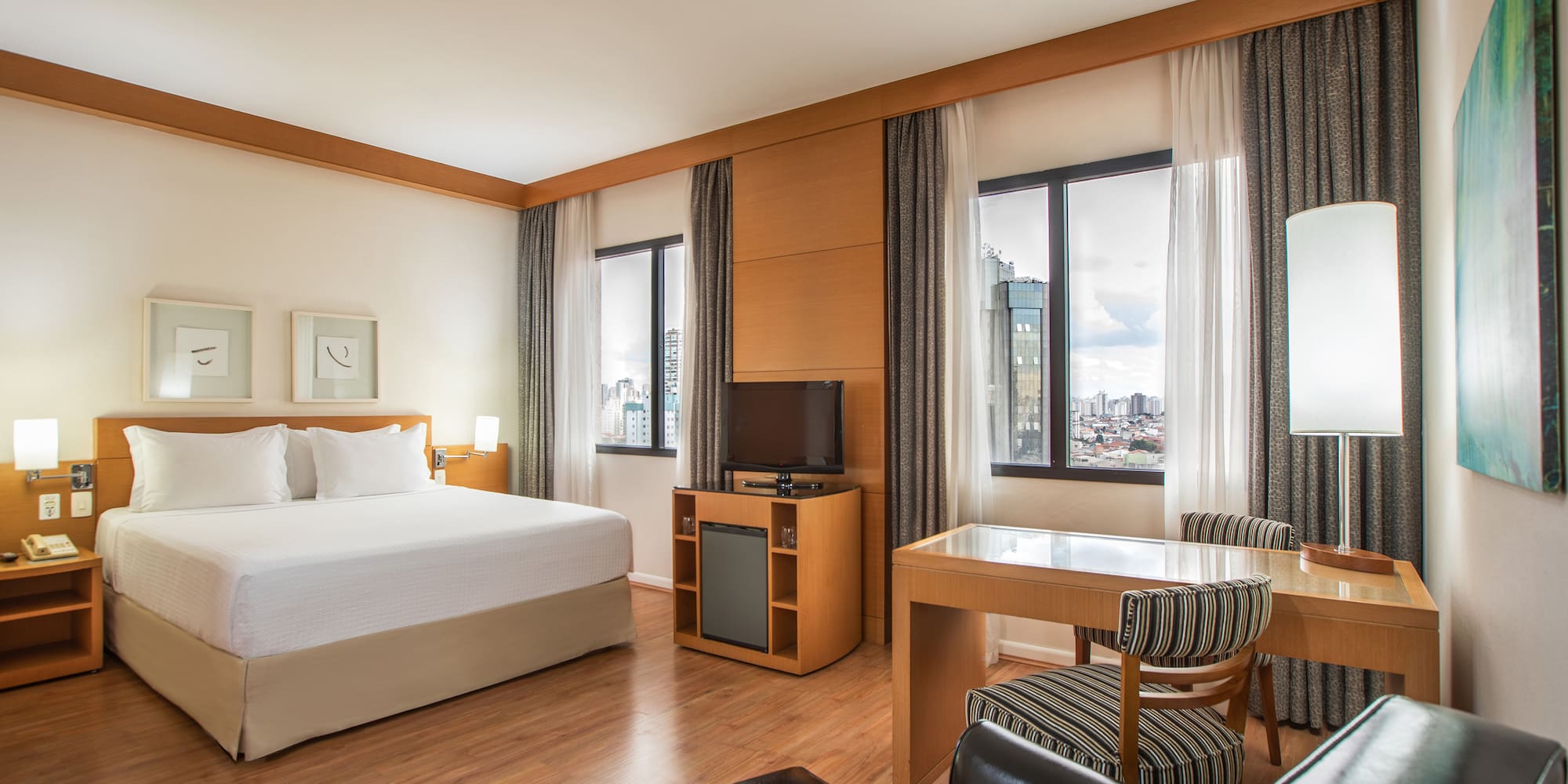 a room with a bed and a table and chairs