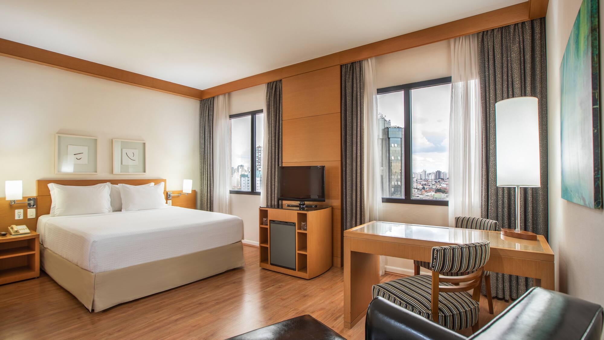 a room with a bed and a table and chairs