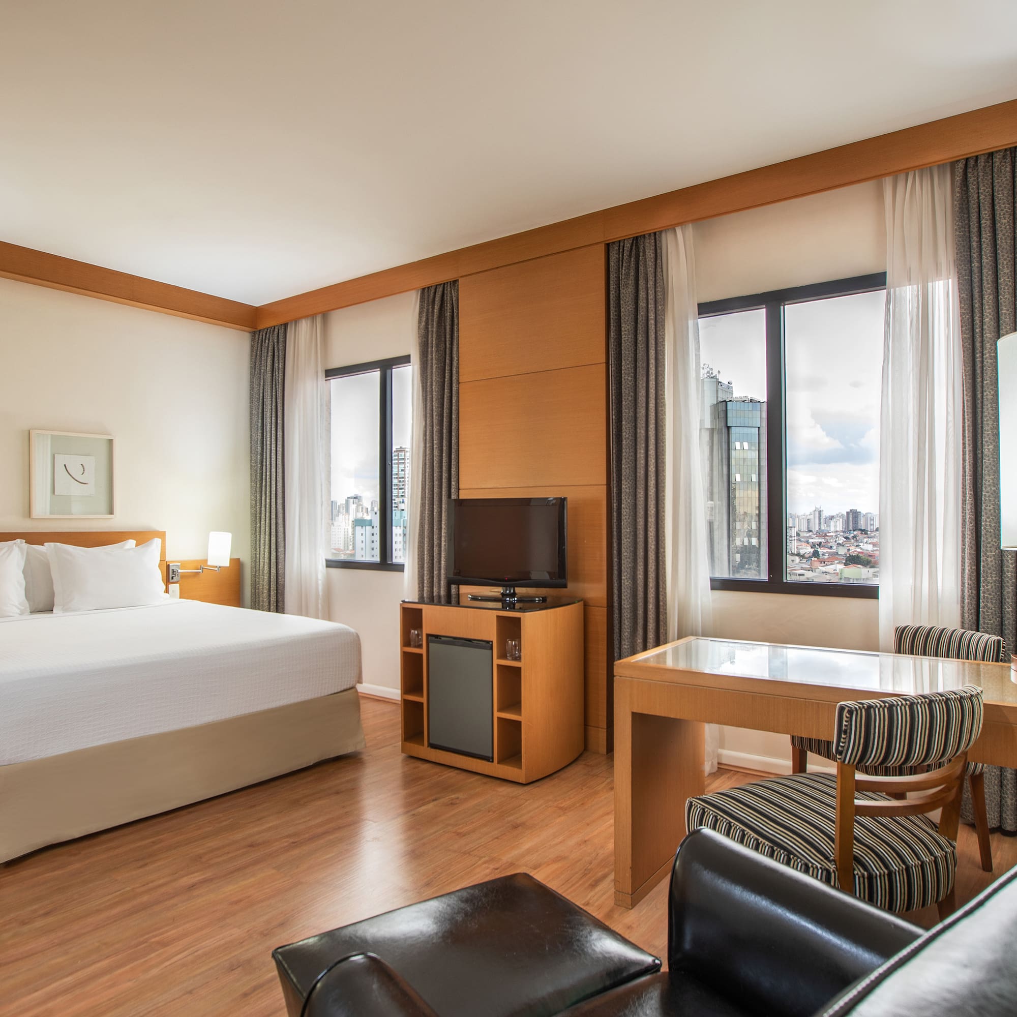 a room with a bed and a table and chairs