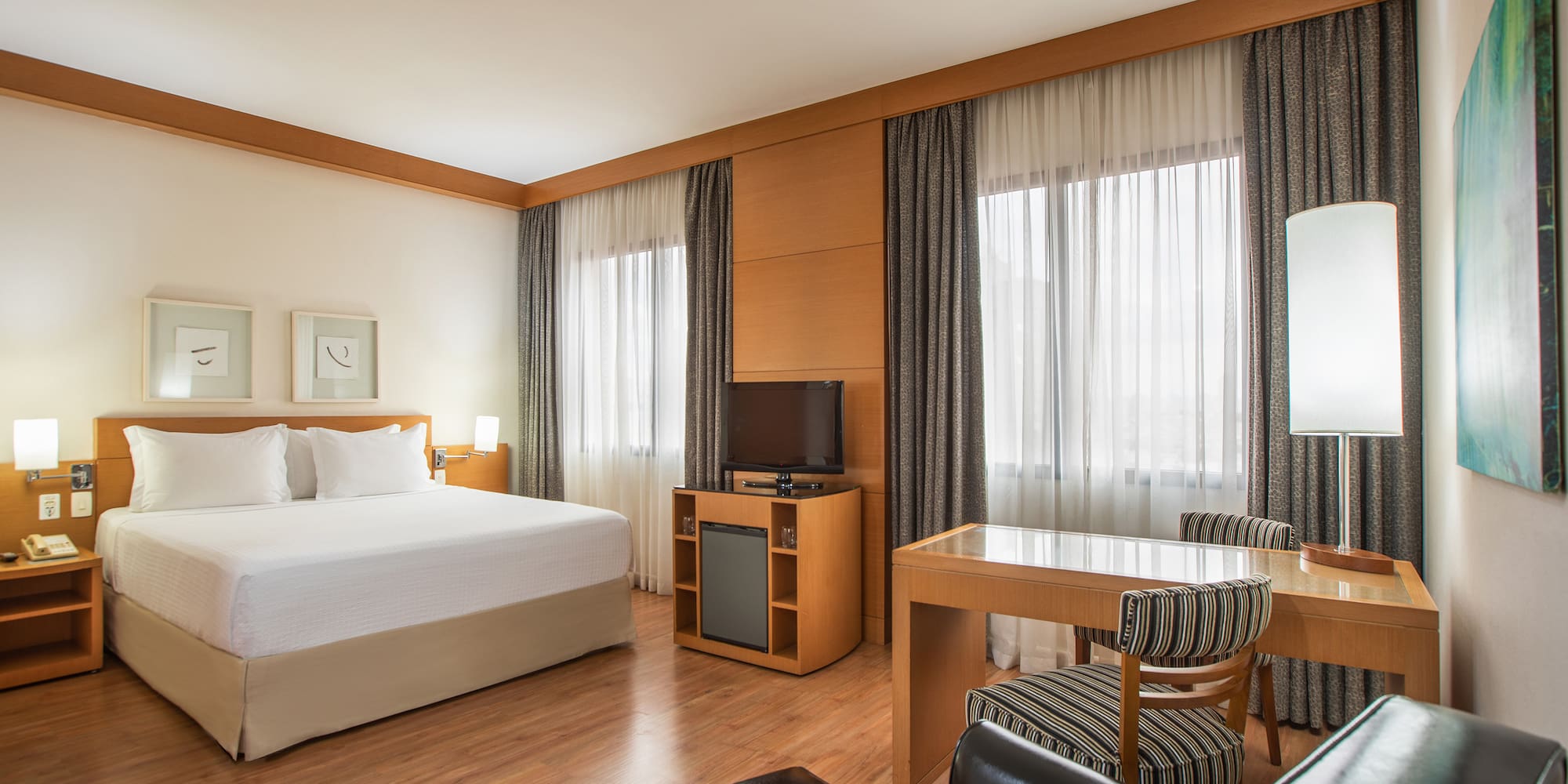 a room with a bed and a table and chairs