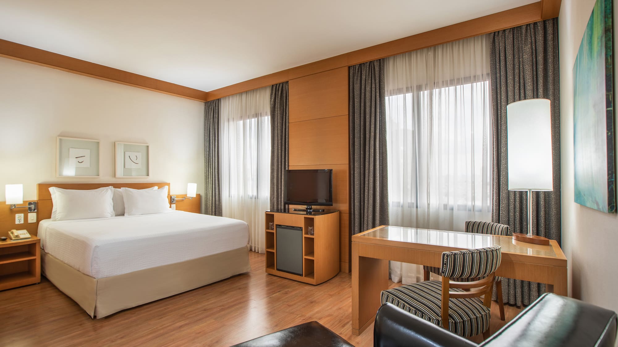 a room with a bed and a table and chairs