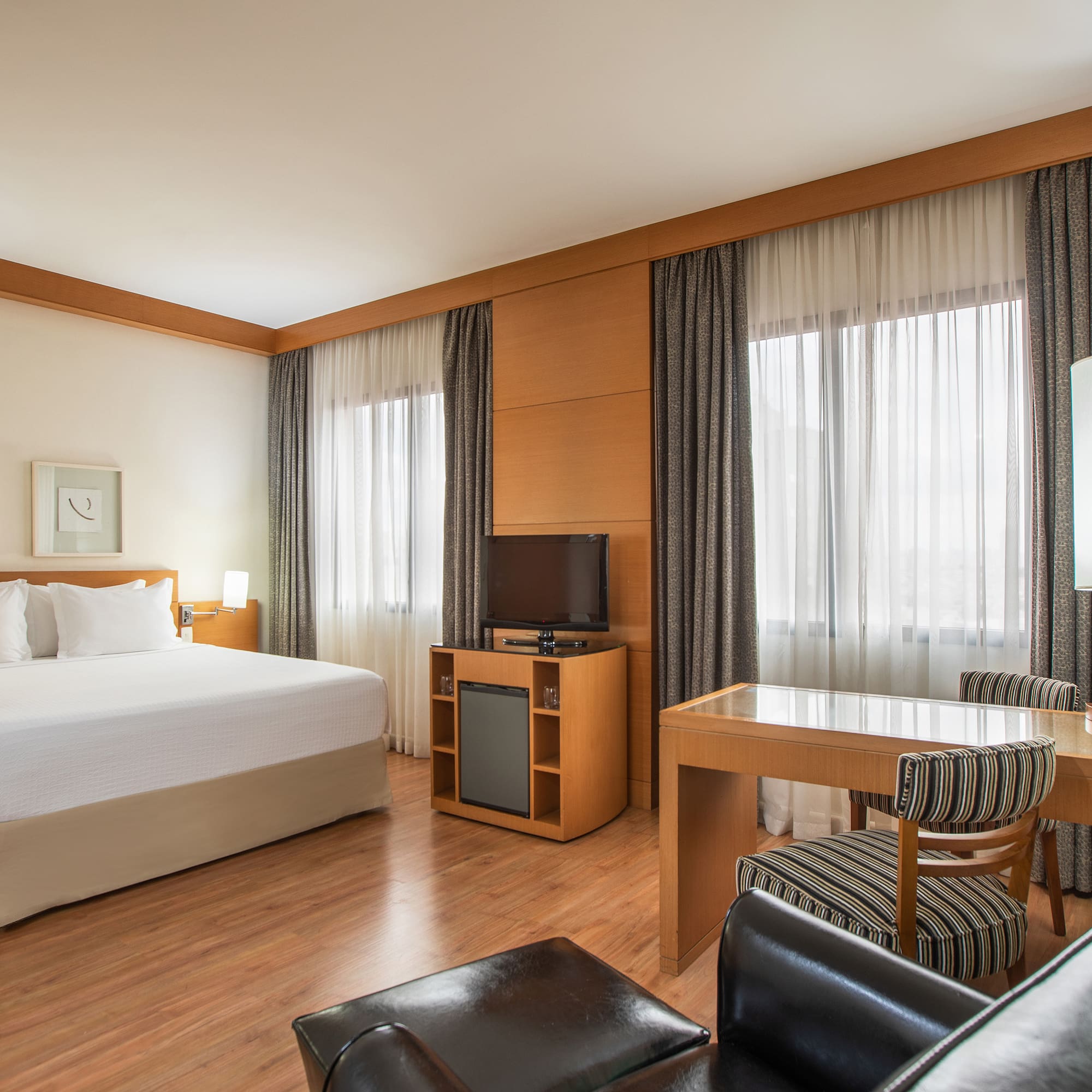 a room with a bed and a table and chairs