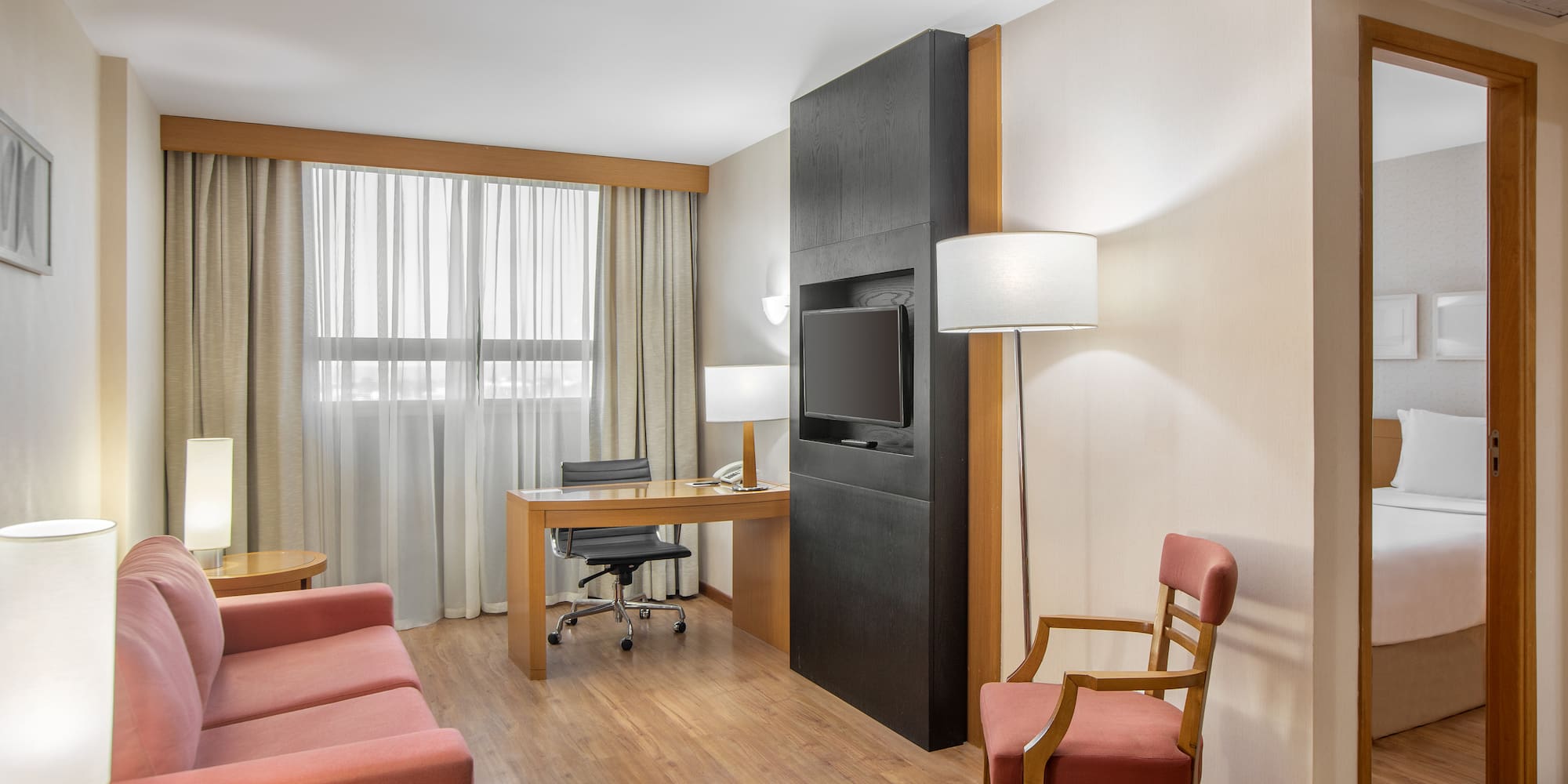 a room with a desk and a tv