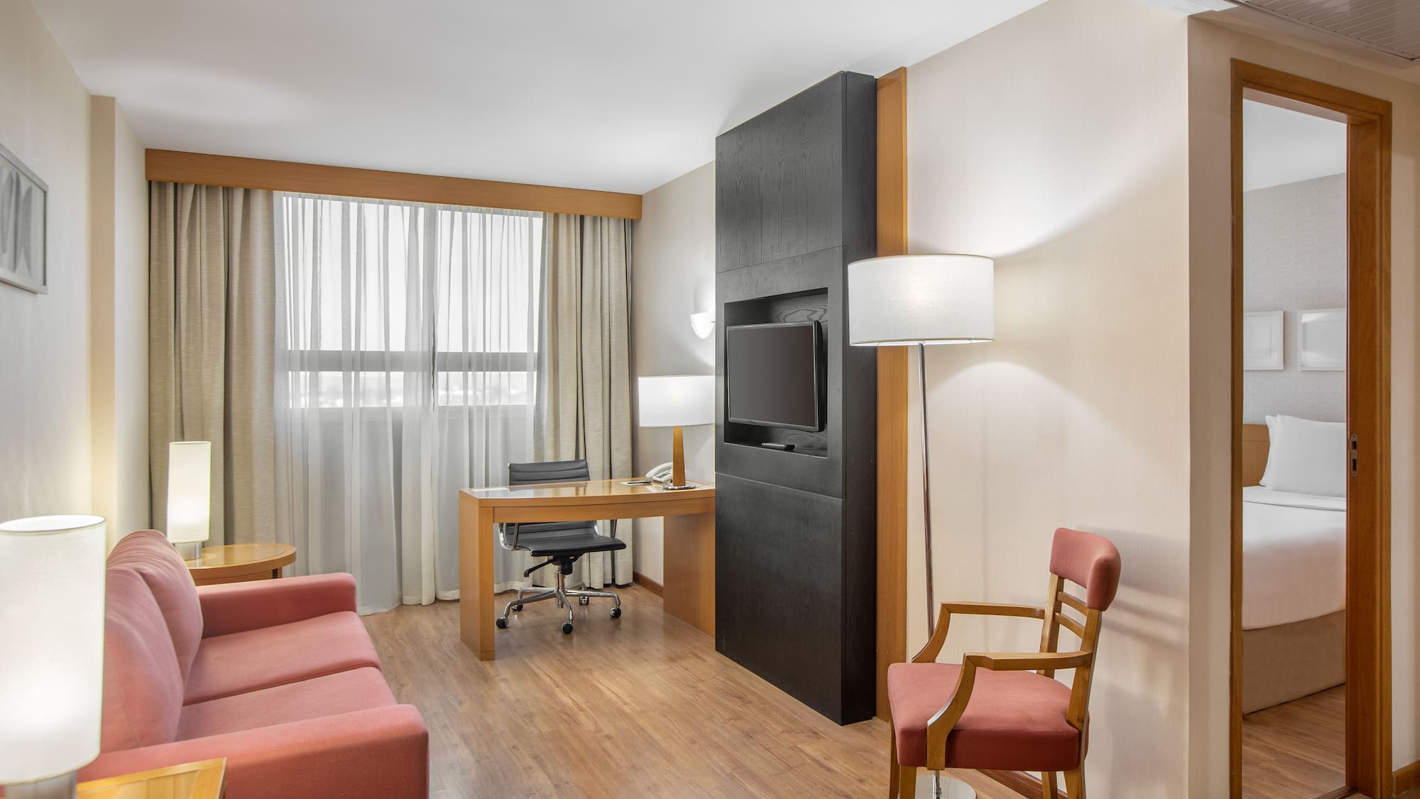 a room with a desk and a tv