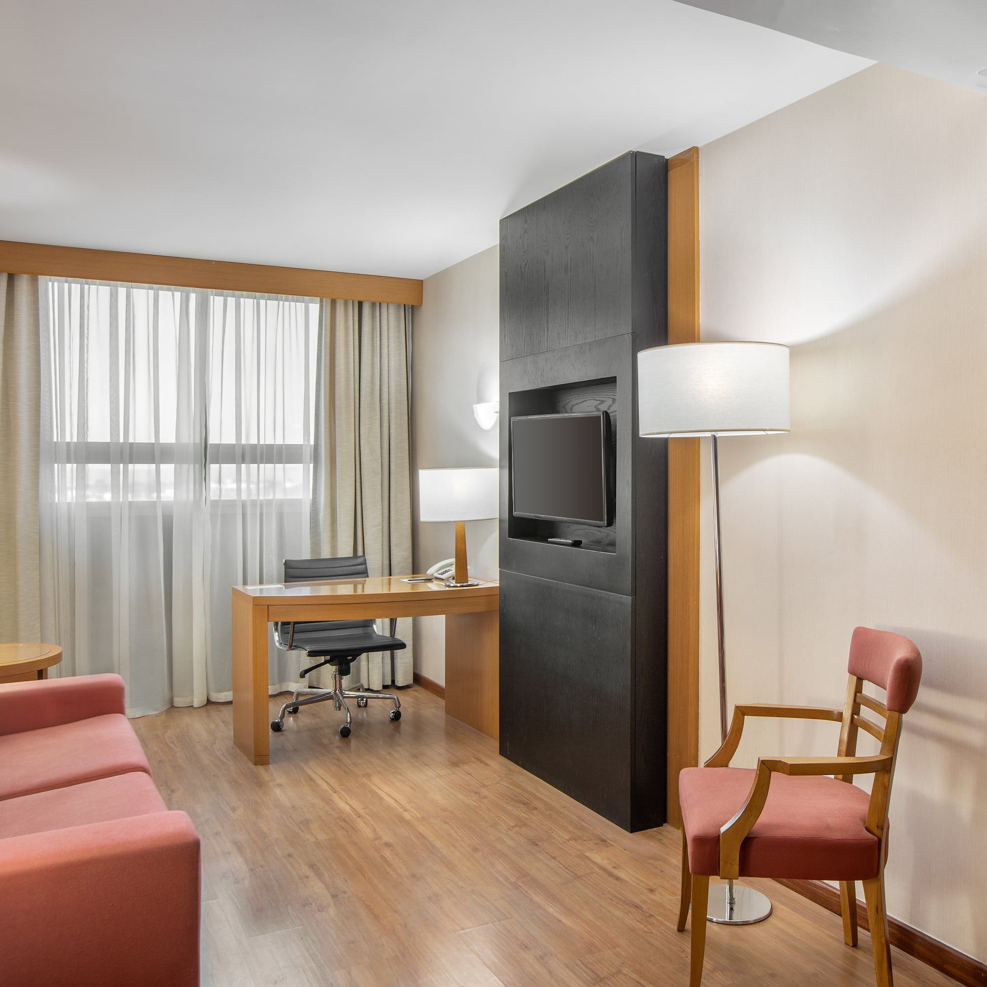 a room with a desk and a tv