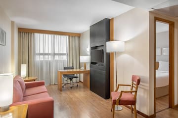 a room with a desk and a tv