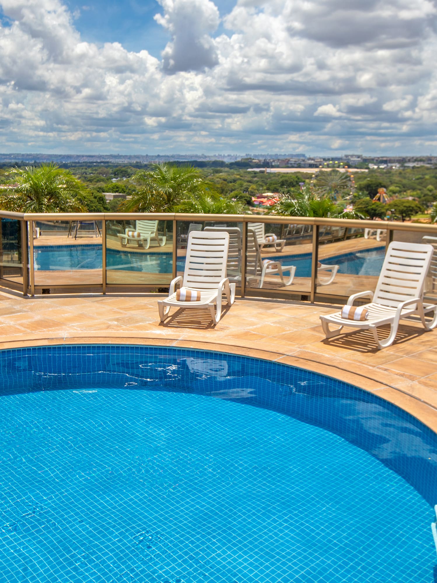a pool with chairs and a table on a deck