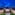 a group of houses with a circular walkway and a blue sky
