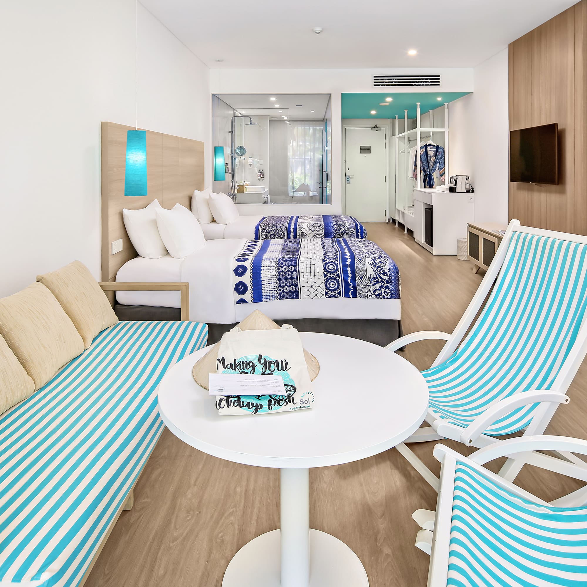 a room with two beds and a table with chairs