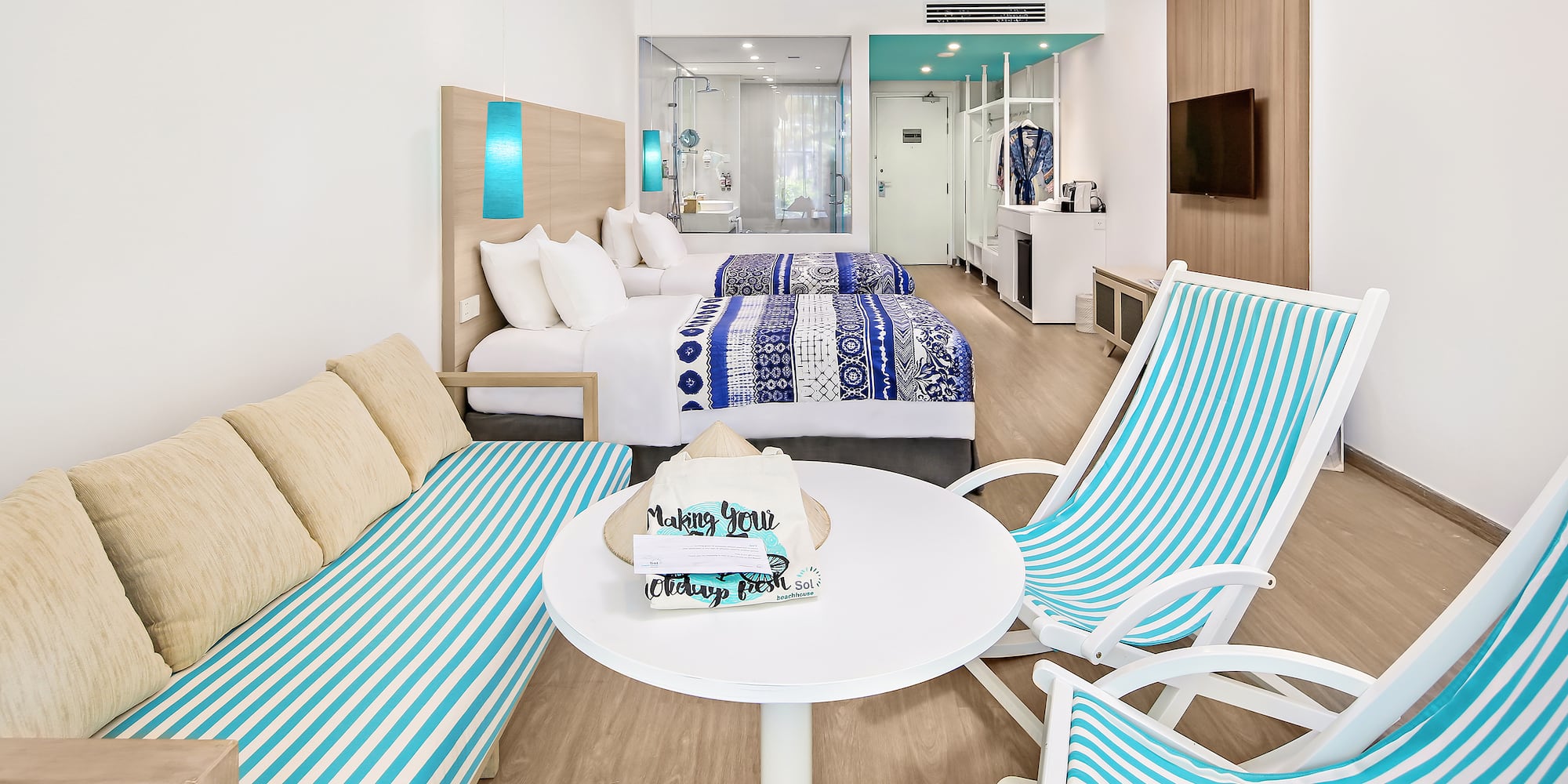 a room with two beds and a table with chairs