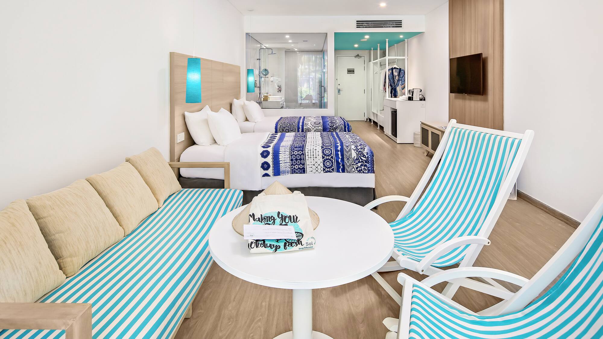 a room with two beds and a table with chairs