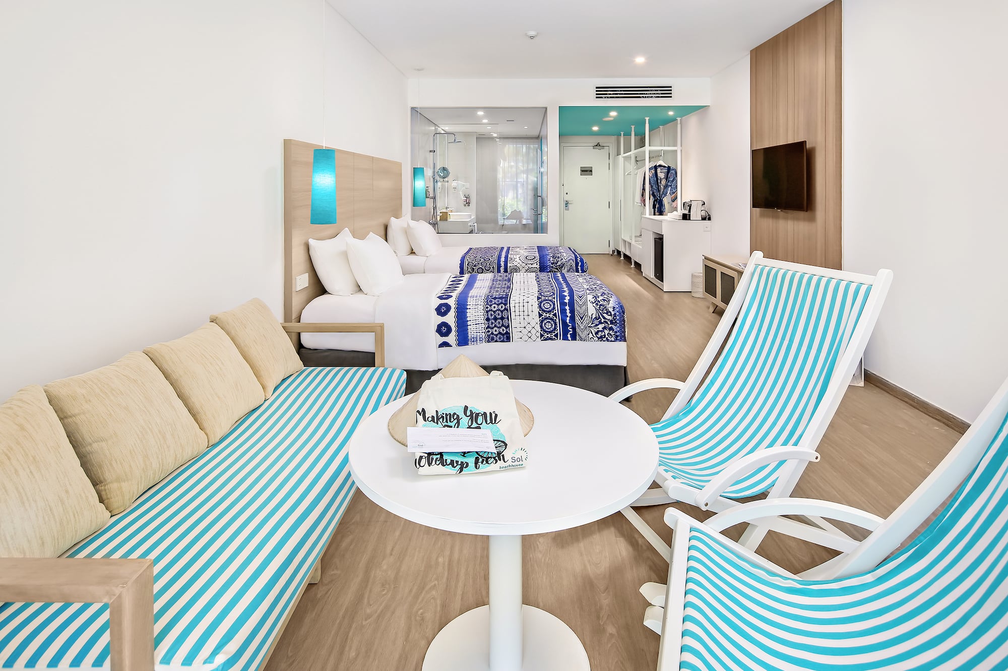 a room with two beds and a table with chairs