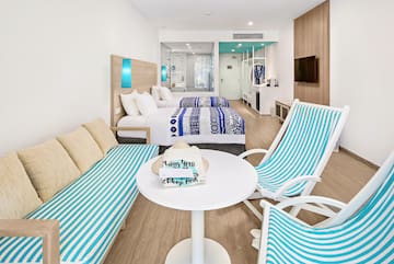 a room with two beds and a table with chairs