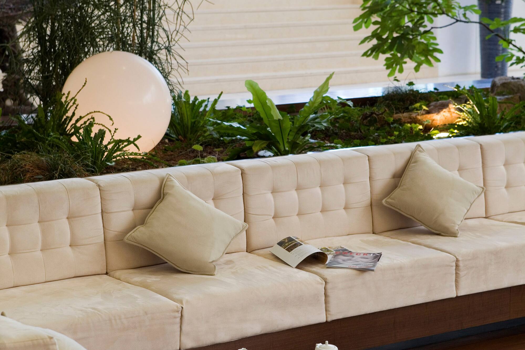 a white couch with pillows and a round table
