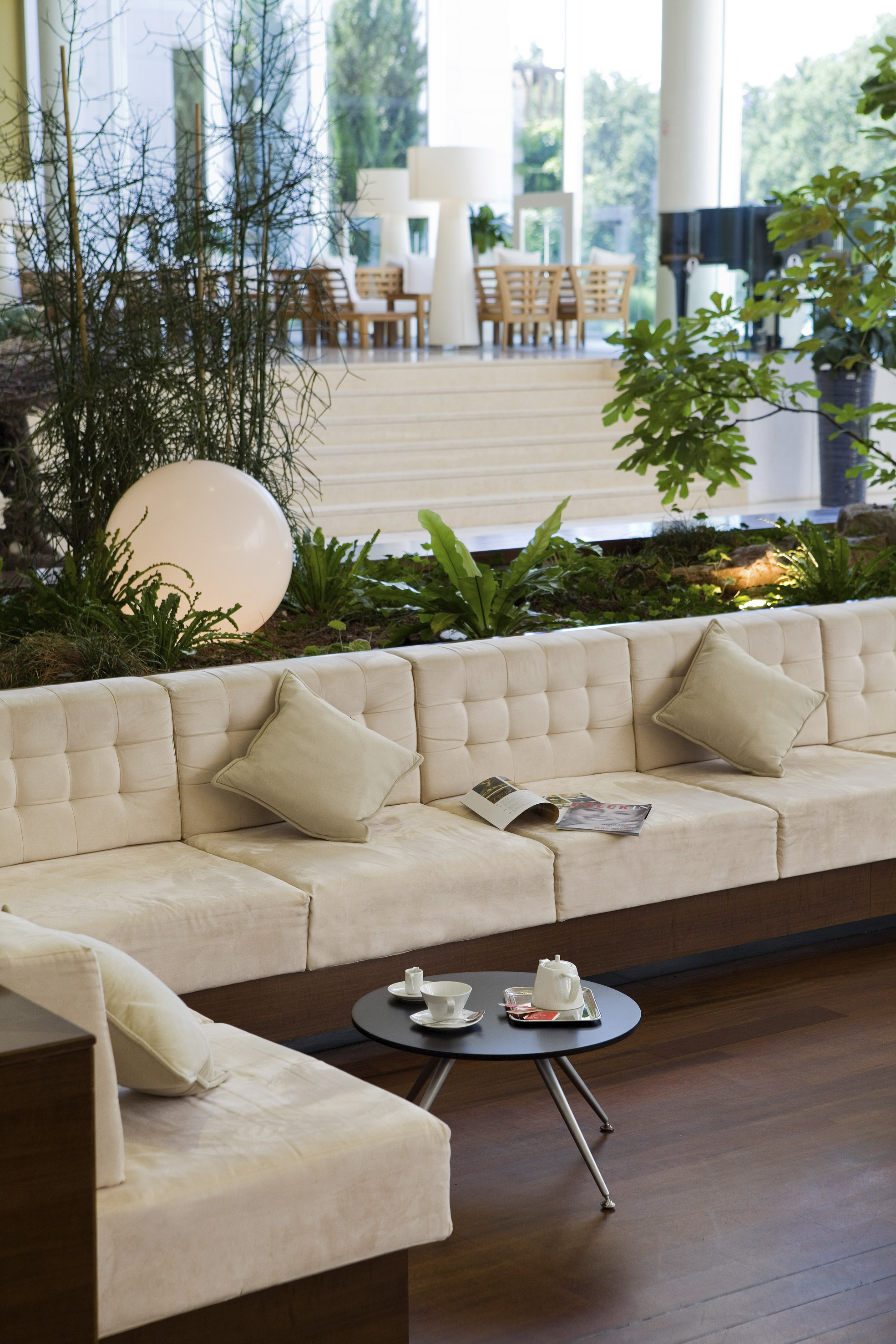 a white couch with pillows and a round table