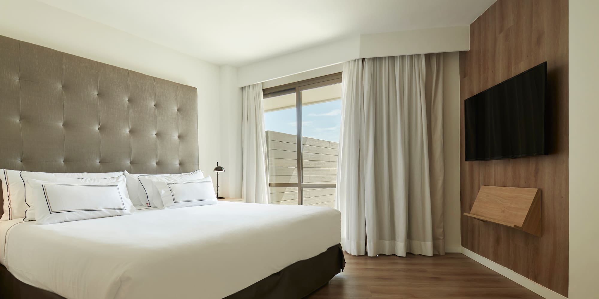 a bedroom with a large bed and a tv